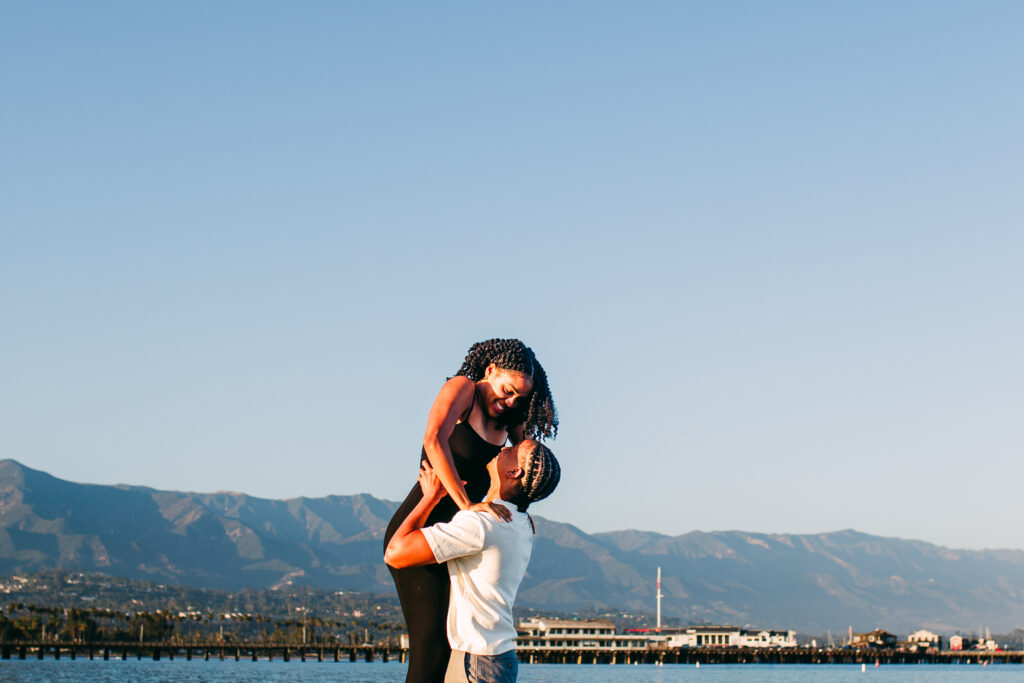 Dancing: Couple dancing at the water's edge during a golden hour Santa Barbara beach engagement session